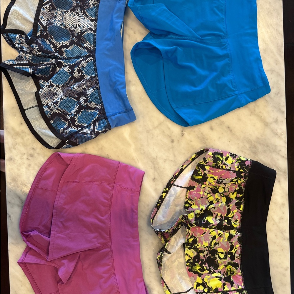 Set of 4 Lululemon shorts.  Blue, Pink, multi, multi